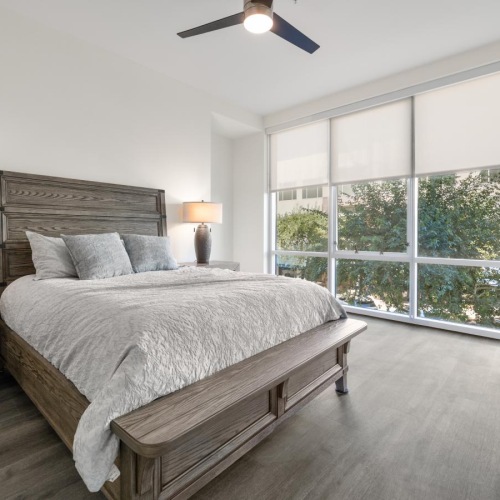 a bed in a room with large windows